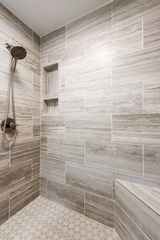 Tiled shower with a recessed niche and a built in bench