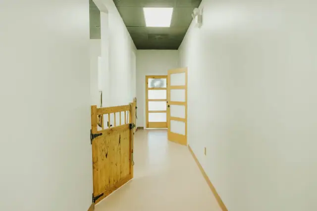 Bright commercial hallway with custom wood half gates