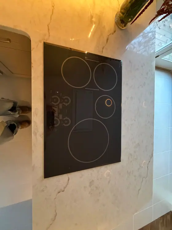Induction cooktop set into a white quartz countertop
